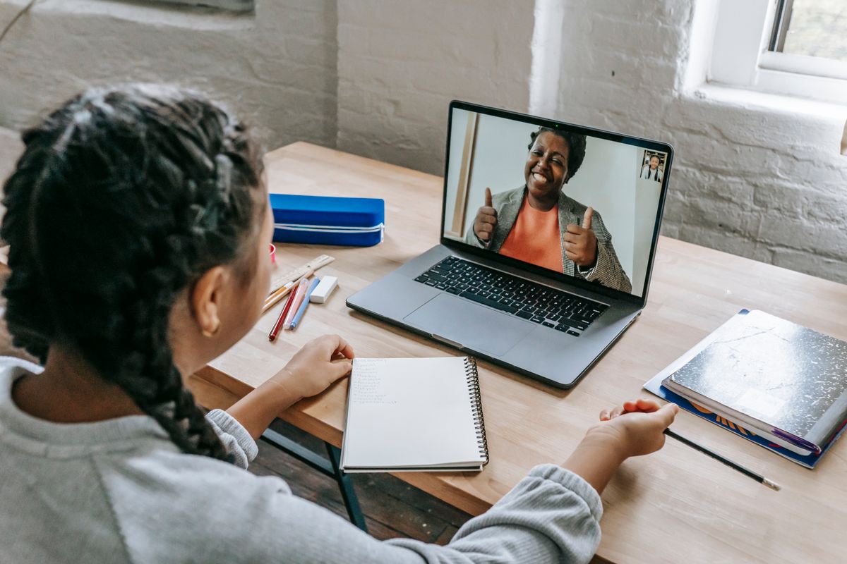 A learner following along with an online course, taking notes